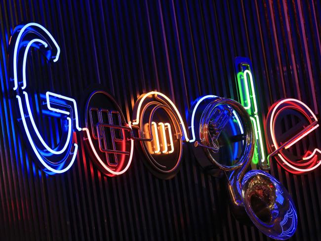 © Bloomberg. The Google Inc. logo hangs illuminated at the company's exhibition stand at the Dmexco digital marketing conference in Cologne, Germany. 