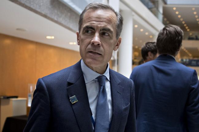 © Bloomberg. Mark Carney, governor of the Bank of England, walks to an International Monetary Fund Committee (IMFC) opening session during the International Monetary Fund (IMF) and World Bank Group Annual Meetings in Washington, D.C., U.S., on Friday, Oct. 7, 2016. The IMF warned this week that rising political tensions over globalization are threatening to derail a world recovery already seeking a reliable growth engine.