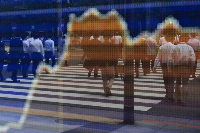 © Bloomberg. Pedestrians crossing the road are reflected in an electronic stock board outside a securities firm in Tokyo, Japan, on Friday, June 9, 2017. Photographer: Noriko Hayashi/Bloomberg