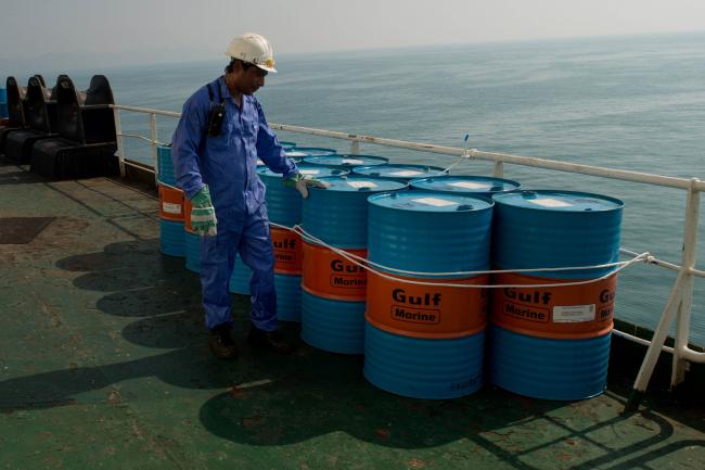© Bloomberg. A crew man secures Gulf Marine oil drums on the deck of oil tanker 'Devon' as it prepares to transport crude oil from Kharq Island to India in Bandar Abbas, Iran, on Friday, March 23, 2018. Geopolitical risk is creeping back into the crude oil market. Photographer: Ali Mohammadi/Bloomberg