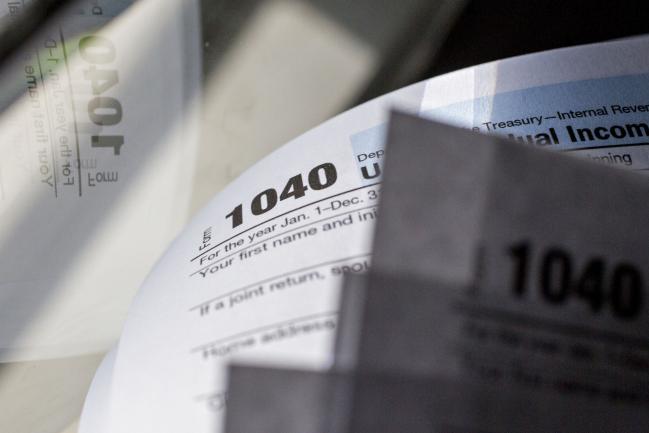 © Bloomberg. U.S. Department of the Treasury Internal Revenue Service (IRS) 1040 Individual Income Tax forms for the 2016 tax year are arranged for a photograph in Tiskilwa, Illinois, U.S., on Monday, Dec. 18, 2017. This week marks the last leg of Republicans’ push to revamp the U.S. tax code, with both the House and Senate planning to vote by Wednesday on final legislation before sending it to President Donald Trump.