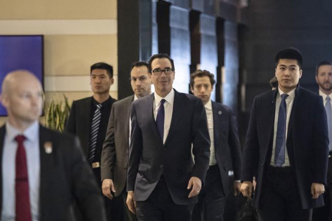© Bloomberg. Steven Mnuchin, U.S. Treasury secretary, center, leaves a hotel in Beijing, China, on Thursday, Feb. 14, 2019. U.S. President Donald Trump said talks to resolve the trade war with China are making good progress, as face-to-face negotiations continue today in Beijing. Photographer: Qilai Shen/Bloomberg