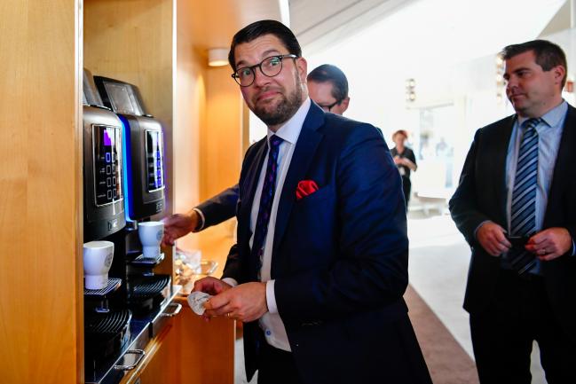 © Bloomberg. Jimmie Akesson, leader of the Sweden Democrats, gets a coffee from a hot drinks machine at the Parliament in Stockholm, Sweden, on Monday, Sept. 24, 2018. The 349-person legislature reconvened on Monday two weeks after an election that saw the nationalist Sweden Democrats grab 62 seats and Prime Minister Stefan Lofven's coalition hang on to a one-seat lead over the center-right Alliance opposition. Photographer: Mikael Sjoberg/Bloomberg