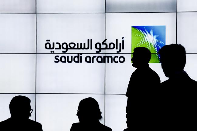 © Bloomberg. A Saudi Arabian Oil Co. (Aramco) logo sits on an electronic display at the company's corporate pavilion during the 22nd World Petroleum Congress in Istanbul, Turkey, on Wednesday, July 12, 2017. Oil�fell from the lowest closing price in two weeks as talk of Libya and Nigeria being requested to cap their production failed to dispel doubts about the effectiveness of OPEC�s cut. 