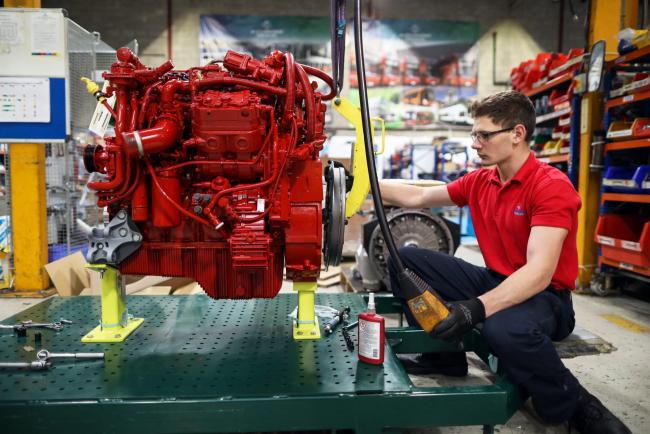 © Bloomberg. An apprentice works on the engine of an Enviro 200 bus at the Alexander Dennis Ltd. factory in Guildford, U.K., on Monday, Sept. 11, 2017. Manufacturing in the U.K. rose in July for the first time this year, boosted by a strong rebound in car production. Vehicle output, which had fallen sharply in recent months, surged almost 14 percent, the most since March 2009, helped by new models rolling off production lines.