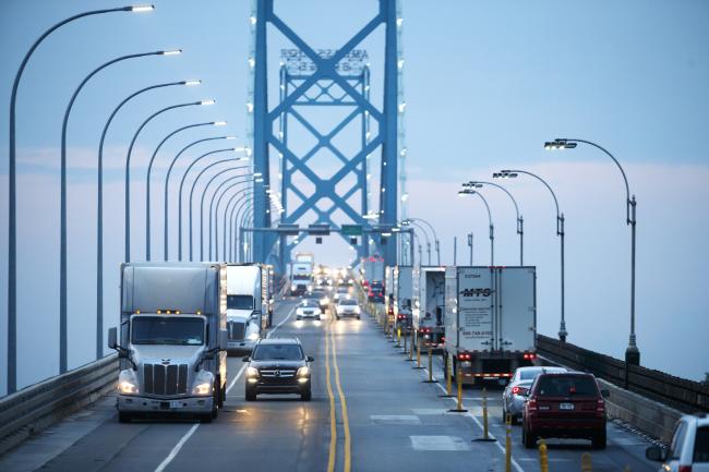 &copy Bloomberg. Commercial trucks and passenger vehicles drive across Ambassador Bridge on the Canada-U.S. border in Windsor, Ontario, Canada, on Thursday, Aug. 9, 2018. The Ambassador Bridge connects Canada to USA, from Windsor to Detroit and facilitates over 30% of all Canada-US road trade. 