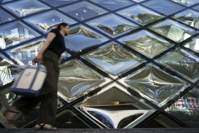 © Bloomberg. A woman walks past a Prada SpA store in the Omotesando area of Tokyo, Japan, on Tuesday, Aug. 21, 2018. Japan is scheduled to release February's Consumer Price Index (CPI) figures on Aug. 23. Photographer: Tomohiro Ohsumi/Bloomberg