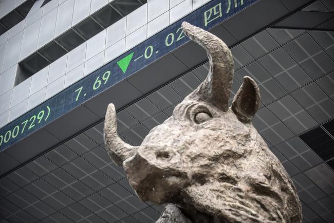 © Bloomberg. A sculpture of a bull stands as an electronic ticker board displays stock prices overhead at the Shenzhen Stock Exchange in Shenzhen, China, on Tuesday, Aug. 23, 2016. 