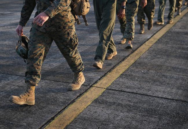 © Bloomberg. MONROVIA, LIBERIA - OCTOBER 09: U.S. Marines arrive as part of Operation United Assistance on October 9, 2014 in Monrovia, Liberia. Some 90 Marines, the largest group of U.S. military yet, arrived on KC-130 transport planes and MV-22 Ospreys to support the American effort to contain the Ebola epidemic. The four Ospreys, which can land vertically like helicopters, will transport U.S. troops and supplies as they build 17 Ebola treatment centers around Liberia. U.S. President Barack Obama has committed up to 4,000 troops in West Africa to combat the disease. (Photo by John Moore/Getty Images)