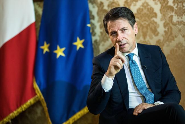 © Bloomberg. Giuseppe Conte, Italy's prime minister, gestures as he speaks during an interview at Chigi palace in Rome, Italy, on Tuesday, Oct. 23, 2018. Conte insisted his government has no 