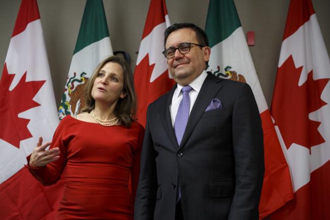 © Bloomberg. Chrystia Freeland and Ildefonso Guajardo Villarreal. Photographer: Cole Burston/Bloomberg