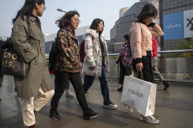 © Bloomberg. Pedestrians and shoppers walk through the Xidan area of Beijing, China, on Saturday, Nov. 3, 2018. As exporters feel the heat of the trade war, China's powerful domestic-consumption engine was supposed to provide some protection for investors in the nation's stocks. That's not working out so well. A narrative that's captured traders' attention in recent weeks has been a “consumption downgrade” in the world's second-biggest economy. 