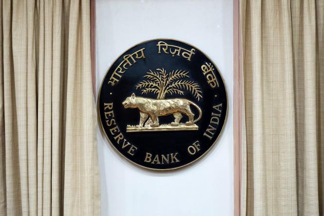 © Bloomberg. The Reserve Bank of India (RBI) logo is displayed inside the central bank building in Mumbai, India, on Wednesday, Dec. 5, 2018. India's central bank kept interest rates unchanged for a second straight meeting as inflation and economic growth slowed in Asia’s third-largest economy. 