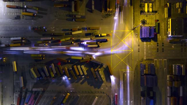 © Bloomberg. Light trails left by trucks run past other trucks at the Yangshan Deepwater Port, operated by Shanghai International Port Group Co. (SIPG), at night in this aerial photograph taken in Shanghai, China on Wednesday, Jan. 30, 2019. The U.S. and China launched high-level trade talks in Washington with little indication that Beijing will bend to U.S. demands to deepen economic reforms. Photographer: Qilai Shen/Bloomberg