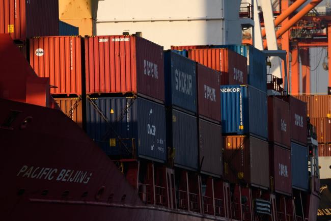 © Bloomberg. Containers sit stacked on a ship at a terminal in Yokohama, Japan, on Monday, Feb. 18, 2019. Japan is sticking to its view that the U.S. won’t apply higher tariffs on imports of Japanese cars and auto parts so long as negotiations toward a trade deal continue, according to Tokyo’s lead negotiator with Washington. Negotiations over a trade deal announced last September by Trump and Abe have yet to start, partly due to ongoing talks between Washington and Beijing. Photographer: Akio Kon/Bloomberg