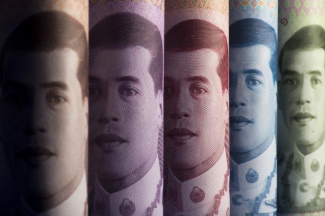 © Bloomberg. The portrait of Thai King Maha Vajiralongkorn is displayed on 1,000, from left, 500, 100, 50 and 20 baht banknotes in an arranged photograph in Bangkok, Thailand, on Wednesday, Sept. 12, 2018. The baht has been a stand-out currency amid the recent rout in emerging markets. It's appreciated 1.5 percent against the dollar so far this quarter, the best performer among major Asian currencies and the only gainer among them. Photographer: Brent Lewin/Bloomberg