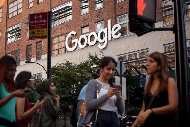 © Bloomberg. Pedestrians walk past the Google Inc. offices in New York, U.S., on Tuesday, Aug. 22, 2016. Wal-Mart Stores Inc. is teaming up with Google to let shoppers order by voice, the latest example of the world's largest retailer finding a technology partner to catch e-commerce leader Amazon.com Inc.