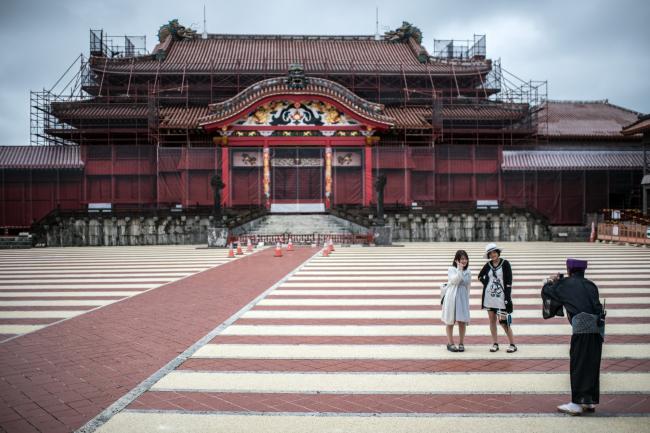 © Bloomberg. Tourists at Shuri Castle in Naha, Okinawa. Photographer: Carl Court/Getty Images