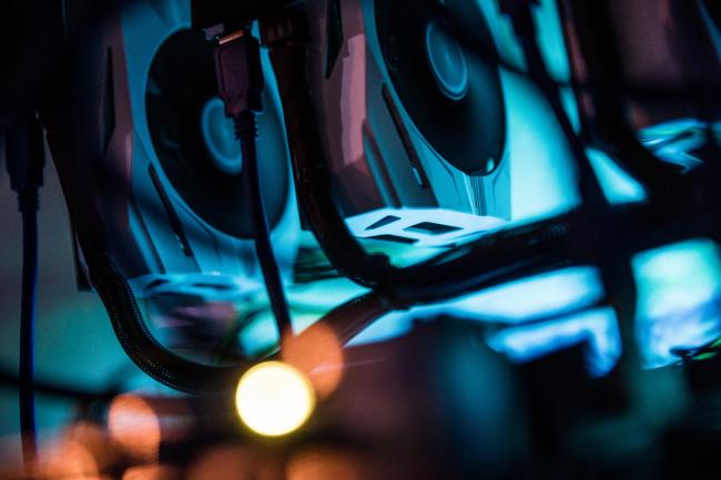 © Bloomberg. Nvidia graphic processing units (GPU) sit stacked inside a 'mining rig' computer.