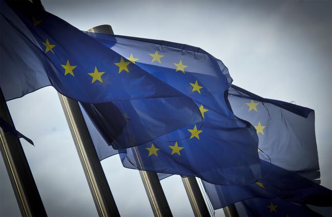 © Bloomberg. European Union (EU) flags fly outside the the European Commission headquarters, in Brussels, Belgium, on Monday, Dec. 19, 2011. European finance ministers will today seek to meet a self-imposed deadline for drawing additional aid to the debt crisis and to form new budget rules as investor confidence that a comprehensive solution is achievable wanes. 