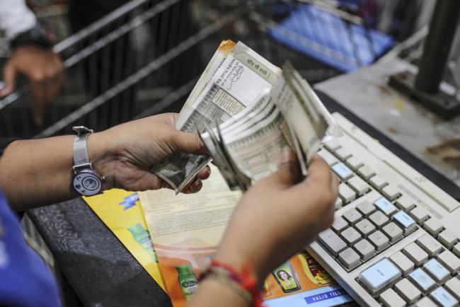© Bloomberg. An employee counts Indian rupee banknotes at a Walmart Inc. Best Price Modern Wholesale store in Hyderabad, India, on Saturday, March 16, 2019. Walmart is making friends in India with the kind of competitors that it spent decades putting out of business in the U.S. -- mom and pop stores. These unlikely allies are part of the retailer's latest attempt to crack the country’s giant consumer market, taking on e-commerce arch-rival Amazon.com Inc. and Asia's richest man, Mukesh Ambani. Photographer: Dhiraj Singh/Bloomberg