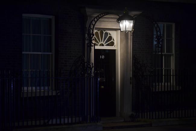 © Bloomberg. A lamp illuminates the door at number 10 Downing Street in London, U.K., on Tuesday, March 12, 2019. U.K. Prime Minister Theresa May struck a deal to revise the terms of the U.K.'s divorce from the European Union but it's unclear whether she's done enough to win Parliament's support in a crucial vote on Tuesday. 