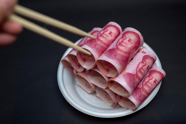 © Bloomberg. Chinese one-hundred yuan banknotes are arranged for a photograph in Hong Kong, China, on Monday, April 15, 2019. China's holdings of Treasury securities rose for a third month as the Asian nation took on more U.S. government debt amid the trade war between the world’s two biggest economies. Photographer: Paul Yeung/Bloomberg