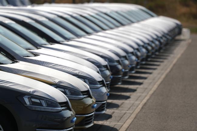 © Bloomberg. Protective covers rest on new Volkswagen AG (VW) automobiles as they sit stockpiled in a parking lot at Willy Brandt Berlin Brandenburg International Airport in Schoenefeld, Germany, on Friday, Aug. 17, 2018. Volkswagen said earlier this year that the company may experience inventory build-up ahead of the Sept. 1 introduction of the Worldwide Harmonized Light-Duty Test Procedure, or WLTP. 