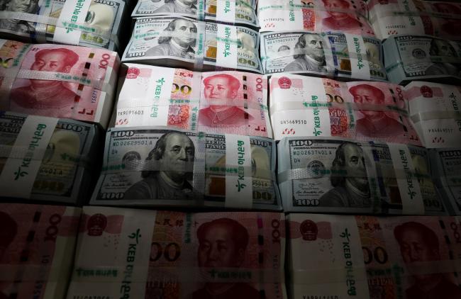 © Bloomberg. Genuine bundles of Chinese one-hundred yuan banknotes and U.S. one-hundred dollar banknotes are arranged for a photograph at the Counterfeit Notes Response Center of KEB Hana Bank in Seoul, South Korea, on Friday, July 13, 2017. Yuan is set to slide for fifth week, longest losing streak since July 2016, as escalating U.S.-China trade tensions weigh on sentiment. Photographer: SeongJoon Cho/Bloomberg