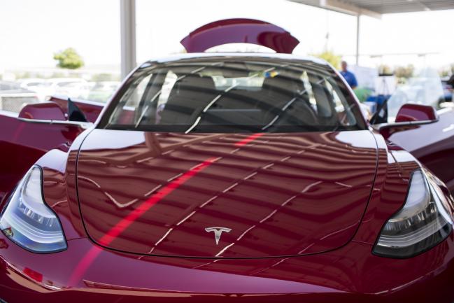 © Bloomberg. A Tesla Inc. Model 3 electric vehicle is displayed during the California Air Resources Board (CARB) 50th Anniversary Technology Symposium and Showcase in Riverside, California, U.S., on Thursday, May 17, 2018. The symposium highlights CARB's history of clean air leadership that has driven innovative solutions and made monumental improvements to Southern California's air quality. Photographer: Dania Maxwell/Bloomberg