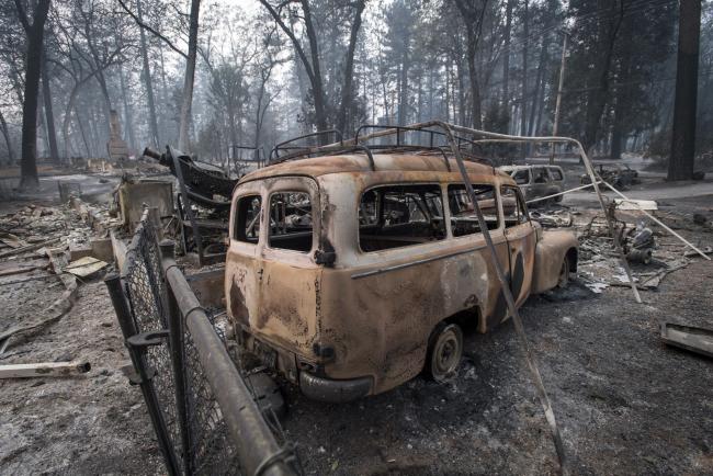 © Bloomberg. A burned-out vehicle stands in Paradise, California, U.S., on Thursday, Nov. 15, 2018. The number of acres burned in the blazes -- including the Hill and Woolsey fires in Southern California, and the Camp fire in Northern California, which has killed at least 48 people and destroyed the city of Paradise -- already is higher than the total burned in wildfires last year, A.M. Best Co. wrote in a report late Tuesday. Photographer: David Paul Morris/Bloomberg