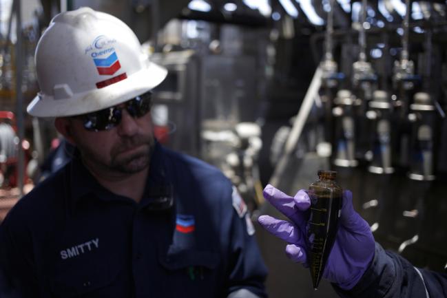 © Bloomberg. Offshore workers examine hydrocarbon samples aboard the Chevron Corp. Jack/St. Malo deepwater oil platform in the Gulf of Mexico off the coast of Louisiana, U.S., on Friday, May 18, 2018. While U.S. shale production has been dominating markets, a quiet revolution has been taking place offshore. The combination of new technology and smarter design will end much of the overspending that's made large troves of subsea oil barely profitable to produce, industry executives say. Photographer: Luke Sharrett/Bloomberg