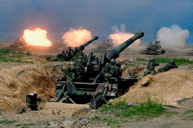 © Bloomberg. US-made CM-11 tanks (in background) are fired in front of two 8-inch self-propelled artillery guns during the 35th 