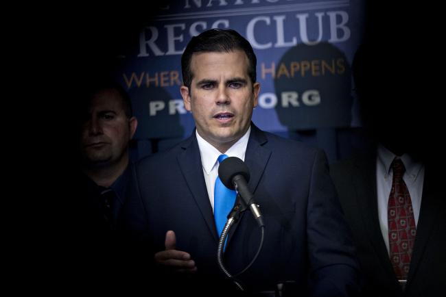 © Bloomberg. Ricardo Rossello, governor of Puerto Rico, speaks during a news conference at the National Press Club in Washington, D.C., U.S., on Thursday, June 15, 2017. Puerto Rico after a May 3 bankruptcy said it can pay less than a quarter of what it owes to creditors over the next ten years, even after it enacts sweeping measures to stabilize the governments finances.