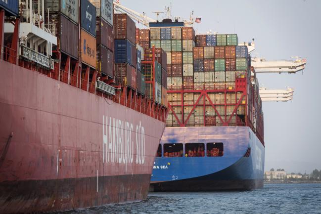 © Bloomberg. Container ships sit docked at the Port of Oakland in Oakland, California. 