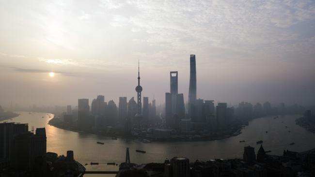 © Bloomberg. The Oriental Pearl Tower, center left, Shanghai World Financial Center, center, and the Shanghai Tower, center right, stand among other buildings in the Lujiazui Financial District along the Pudong riverside in this aerial photograph taken above Shanghai, China, on Monday, April 2, 2018. China's sprawling local government financing system needs 