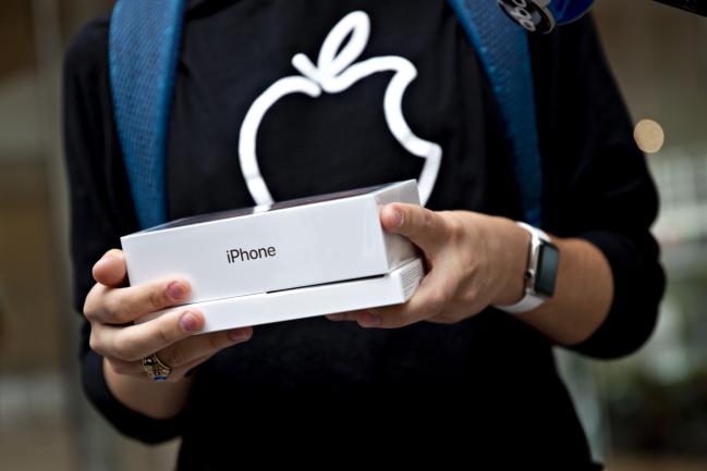 © Bloomberg. A customer holds an Apple Inc. iPhone XS Max box during a sales launch at a store in Chicago, Illinois, U.S., on Friday, Sept. 21, 2018. The iPhone XS is up to $200 more expensive than last years already pricey iPhone X and represents one of the smallest advances in the product lines history. But that means little to the Apple Inc. faithful or those seeking to upgrade their older iPhone. Photographer: Daniel Acker/Bloomberg