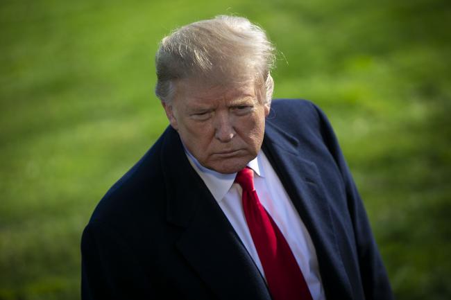 © Bloomberg. U.S. President Donald Trump listens to a question from a member of the media before boarding Marine One on the South Lawn of the White House in Washington, D.C., U.S., on Thursday, March 28, 2019. With the weight of the 22-month Russia probe investigation lifted, Trump today will hold his first political rally since Special Counsel Robert Mueller submitted his final report. 