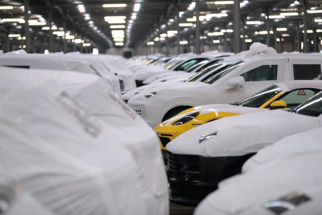 © Bloomberg. Protective covers sit on new Porsche AG automobiles parked in a storage building ahead of export from the BLG Logistics Group AG terminal at the Port of Bremerhaven in Bremerhaven, Germany, on Tuesday, Jan. 22, 2019. Investor confidence in Germany's growth outlook improved at the start of the year amid hopes that growth will stabilize after a turbulent 2018. 