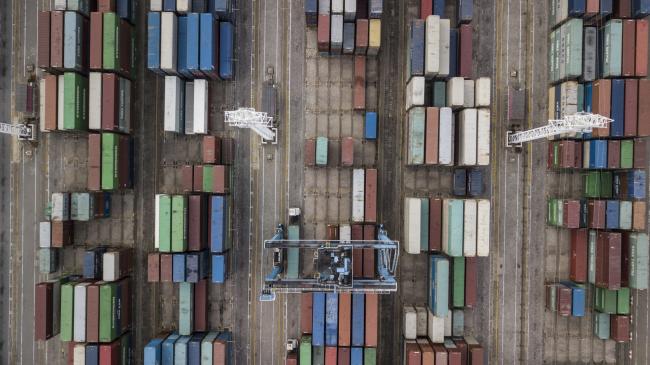 © Bloomberg. Containers sit stacked next to gantry cranes in this aerial photograph taken above the Port of Ningbo-Zhoushan in Ningbo, China, on Wednesday, Oct. 31, 2018. President Donald Trump wants to reach an agreement on trade with Chinese President Xi Jinping at the Group of 20 nations summit in Argentina later this month and has asked key U.S. officials to begin drafting potential terms, according to four people familiar with the matter. 
