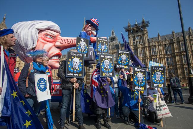 © Bloomberg. Anti-Brexit protesters stand near the Houses of Parliament on April 1. 