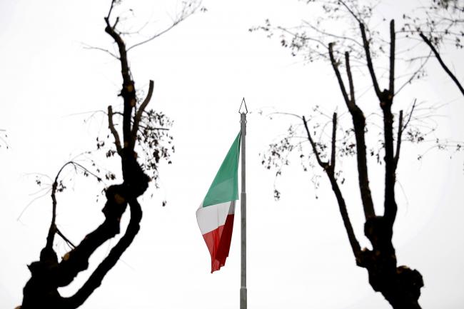 © Bloomberg. An Italian national flag flies from a monument in Genzano, Italy. Photographer: Alessia Pierdomenico