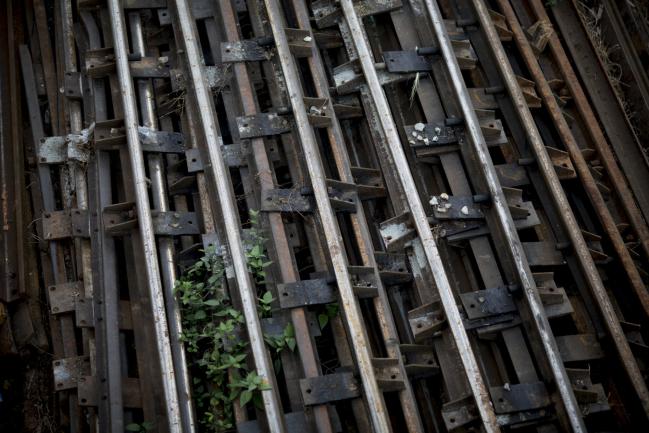 © Bloomberg. Railway tracks sit piled up in a yard at Yangon Central railway station in Yangon, Myanmar, on Tuesday, Jan. 9, 2018. A winner for the Yangon Central Railway Comprehensive Development Project tender is scheduled to be selected next month, according to Myanmar Railways. 