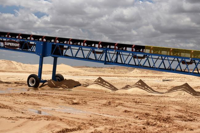 © Bloomberg. A conveyor stands at the Hi-Crush Partners LP sand mining facility in Kermit, Texas, U.S., on Wednesday, June 20, 2018. In the West Texas plains, frack-sand mines suddenly seem to be popping up everywhere. Twelve months ago, none of them existed - together, these mines will ship some 22 million tons of sand this year to shale drillers in the Permian Basin, the hottest oil patch on Earth. Photographer: Callaghan O'Hare/Bloomberg