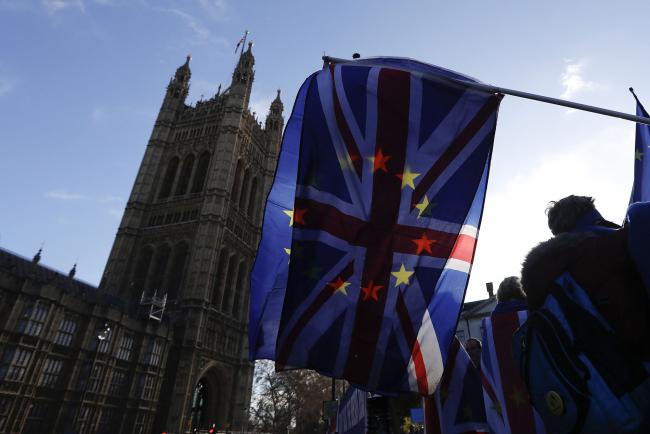 © Bloomberg. A British Union flag, also known as a Union Jack, flies beside a European Union (EU) flag during ongoing pro and anti Brexit protests outside the Houses of Parliament in London. 