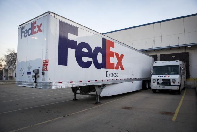 © Bloomberg. Trucks sit parked outside the FedEx Corp. shipping center in Chicago, Illinois, U.S., on Monday, Nov. 27, 2017. The holiday shopping season is off to a strong start and retailers appear to be continuing the momentum today --CyberMonday-- the biggest online spending day of the year.