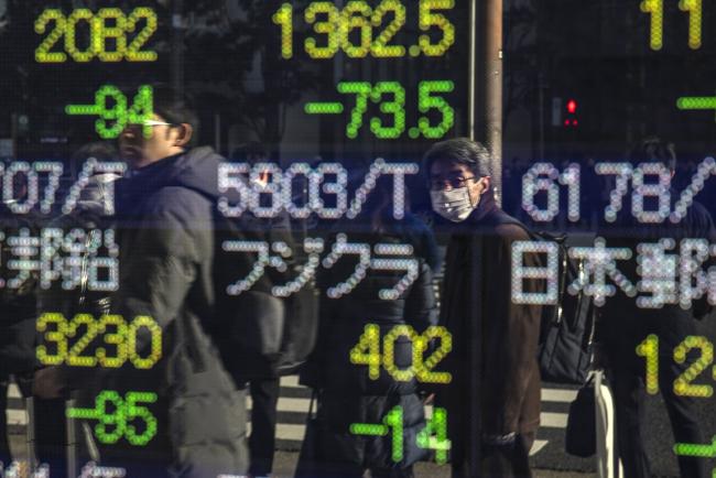 © Bloomberg. An electronic stock board reflects pedestrians outside a securities firm in Tokyo, Japan, on Tuesday, Dec. 25, 2018. The Nikkei 225 Stock Average plunged below the 20,000 level and entered bear market territory, as Japanese equities headed for their worst December on record. Photographer: Shoko Takayasu/Bloomberg