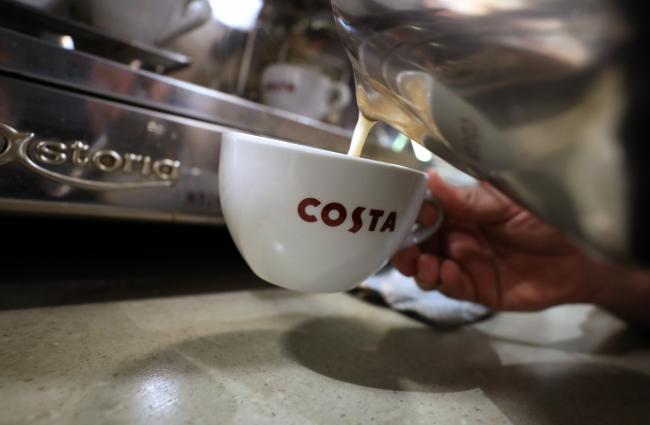 © Bloomberg. A barista pours hot milk into a coffee cup in a Costa Coffee shop, operated by Whitbread Plc, in London, U.K., on Wednesday, May 2, 2018. Whitbread is betting that its faster-growing Costa Coffee chain will compete more effectively against the likes of Starbucks Corp. once separated from the company's hotel business. 