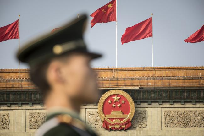 © Bloomberg. A member of the Chinese People's Liberation Army stands guard outside the Great Hall of the People ahead of the closing session of the 19th National Congress of the Communist Party of China in Beijing, China, on Tuesday, Oct. 24, 2017. China's ruling Communist Party approved a revised charter that enshrined PresidentXi Jinping'sname under its guiding principles, elevating him to a status that eluded his two immediate predecessors.