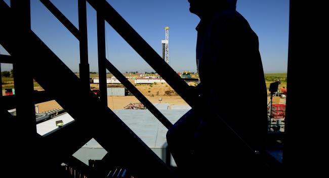 © Bloomberg. The silhouette of a contractor is seen walking up stairs at an Anadarko Petroleum Corp. oil rig site in Fort Lupton, Colorado. Photographer: Jamie Schwaberow/Bloomberg